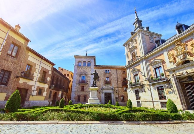 Madrid, Spain. Old town hall at area Placa de la Villa with monument in centre of square. Sunny summer day.