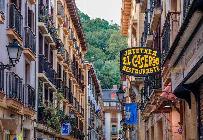 San Sebastian, Spain - June 25, 2021: Basque restaurants and bars famous for pintxos or tapas in the narrow streets of old town Donostia, Basque Country